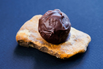 Chocolate truffle on the stone stand