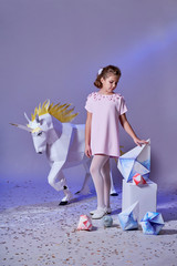 Young kid girl in elegance dress pink. Concept winter, eve, Christmas, new year. Fashion lady...