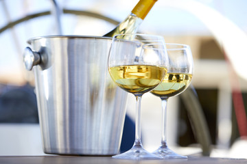 Pair of wineglasses against the yacht