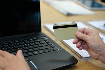 woman holding credit card using computer for online shopping. businesswoman purchase product from internet, make payment on bank website