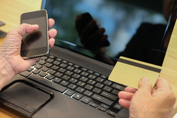 woman holding credit card using smart phone for online shopping. businesswoman purchase product from internet, make payment on bank website