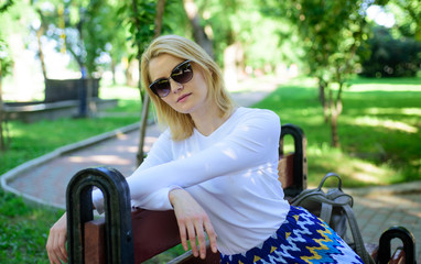 Ways to give yourself break and enjoy leisure. Girl sit bench relaxing in shadow green nature background. Woman blonde take break relaxing in park. Find peaceful place in park. Time for yourself