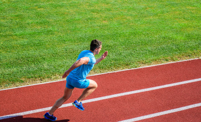 Athlete run track grass background. Runner in motion. Many runners like challenge of extending...