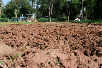farmer in tractor preparing field for seedling. agriculture work at farmland