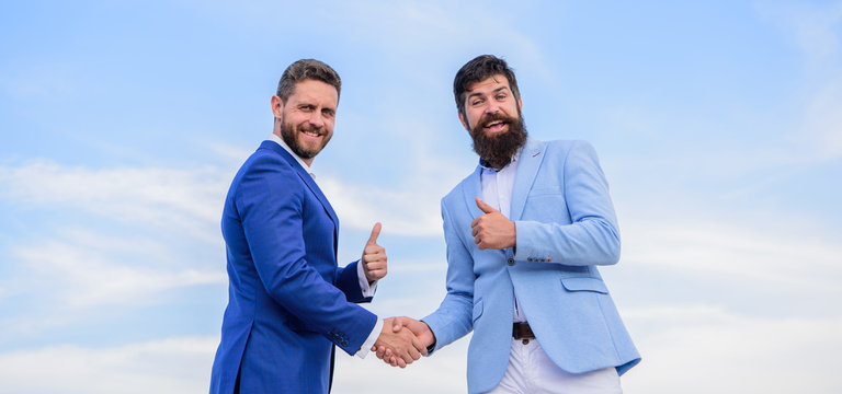 Business partner confirming deal transaction. Men formal suits shaking hands blue sky background. Entrepreneurs shaking hands symbol successful deal. Business deal approved accepted by both partners