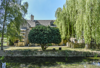 Fototapeta na wymiar england, gloucestershire, village, uk, cotswolds, old, lower slaughter, stone, building, architecture, rural, europe, cotswold, cottage, house, travel, countryside, idyllic, landmark, peaceful, countr