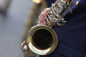 Details of a man holding a saxophone