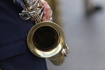 Details of a man holding a saxophone