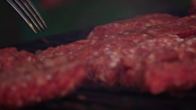 Romanian traditional food Meat Balls "mici" on grill. Slow motion

