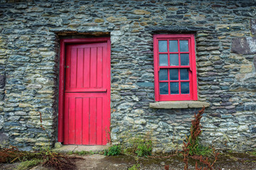 Vintage door and window on a facade of an old cottage in Ireland