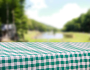
Green tablecloth in a cage with nature background