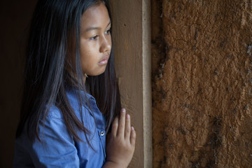  Portrait of a poor little thailand girl lost in deep thoughts, poverty, Poor children