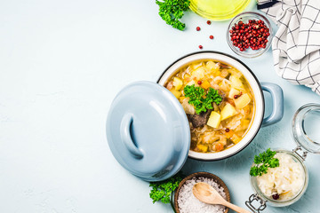 Traditional sauerkraut soup, shchi with meat and vegetables. Top view, space for text.