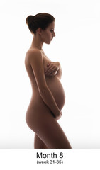 Beautiful pregnant woman expecting baby isolated on white.