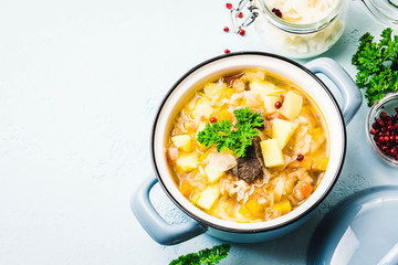 Traditional sauerkraut soup, shchi with meat and vegetables. Top view, space for text.