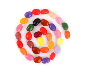 Jelly beans in the form of a spiral on a white background