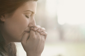 Lonely and depressed sad woman with hands on face