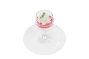 Fototapeta na wymiar Panna cotta dessert with whipped cream, isolated on a white background in glass with a taste of berries, strawberries, cherries, watermelon, a leaf of mint, powdered sugar on a plate, side view