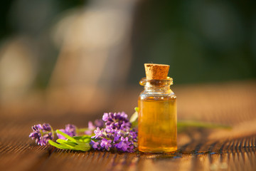 Obraz na płótnie Canvas lavender essential oil in beautiful bottle on table