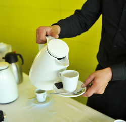 Waiter at the catering service, coffee break