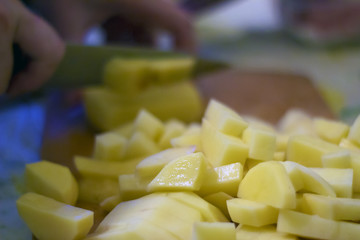 Sliced, peeled raw potatoes on a board. potato preparation process