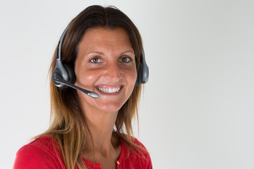 Support phone operator woman in headset at workplace in grey wall background