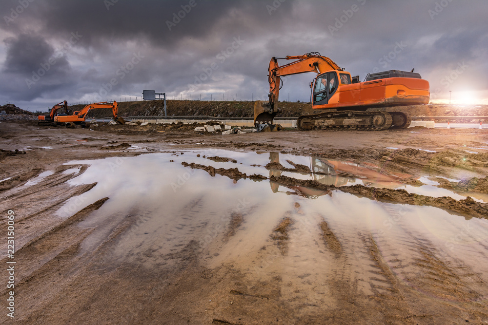 Wall mural works in the construction of a road extracting stone in a hard day of winter work