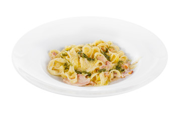 Pasta, noodles with bacon and sauce pesto, decorated with cheese. Side view. Serving a meal in a cafe, restaurant. Isolated white