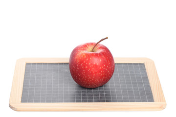 school concept: a red apple  on a chalk board isolated on white background