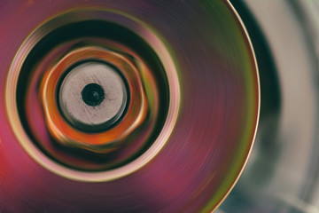 Part of rotating mechanism close-up. Brutal auto part in pink tone with gold shine. Colorful bckground of metal device.