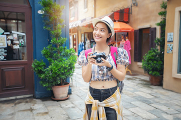 Asian women backpacks walking together and happy  are taking photo and selfie ,Relax time on holiday concept travel