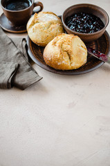Simple breakfast: coffee americano, fresh buns and jam.
