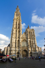 Fototapeta na wymiar Beautiful wide angle view of the Cathedral of Our Lady (Onze-Lieve-Vrouwekathedraal) seen from the Handschoenmarkt in Antwerp, Belgium, on a summer day with a blue sky