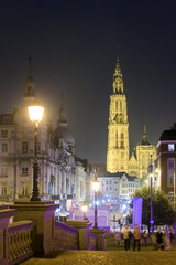 Beautiful view of the Cathedral of Our Lady (Onze-Lieve-Vrouwekathedraal) and a street light lantern at night in Antwerp, Belgium

