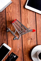concept online shopping with smartphone on wooden background moc