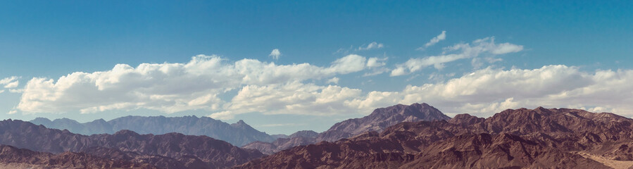 Landscape of mountain peaks at cloudy sky