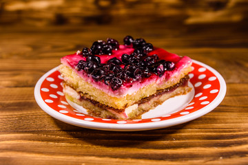 Ceramic plate with cheesecake on wooden table