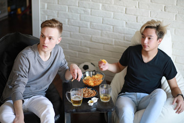 Football fans watch the match and drink beer
