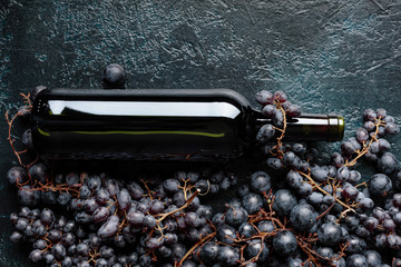 Bottle of red wine and grapes.