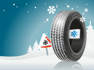 The winter tire is ready to the winter road. An automobile tire against the background of snow and the sign about the snow road.