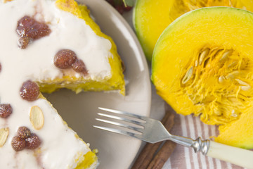 Pumpkin homemade cheesecake with white cream. Autumn still life. Thanksgiving day food.