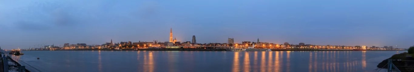 Foto op Plexiglas Beautiful cityscape panorama of the skyline of Antwerp, Belgium, during the blue hour seen from the shore of the river Scheldt © dennisvdwater