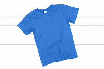 Blue T-Shirt on a White Wooden Background