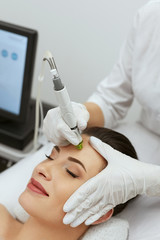 Face Skin Care. Woman Getting Facial Hydro Exfoliating Treatment