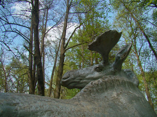 Old elk sculpture in the spring park - 223162017