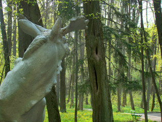 Old elk sculpture in the spring park - 223162044