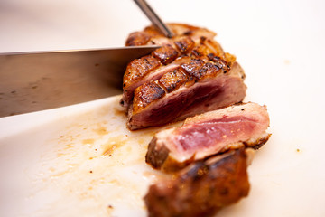 Perfect cooked duck berast in restaurant kitchen. Chef making delicious meal