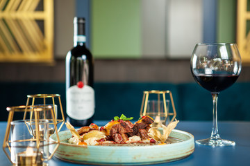 Delicious breast duck with mash potato and red wine on the table. Fine cuisine