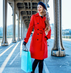 tourist woman with shopping bag in Paris looking into distance