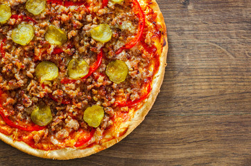 Pizza with Mozzarella cheese, minced meat and vegetables. Italian pizza on wooden background. with copy space. top view
